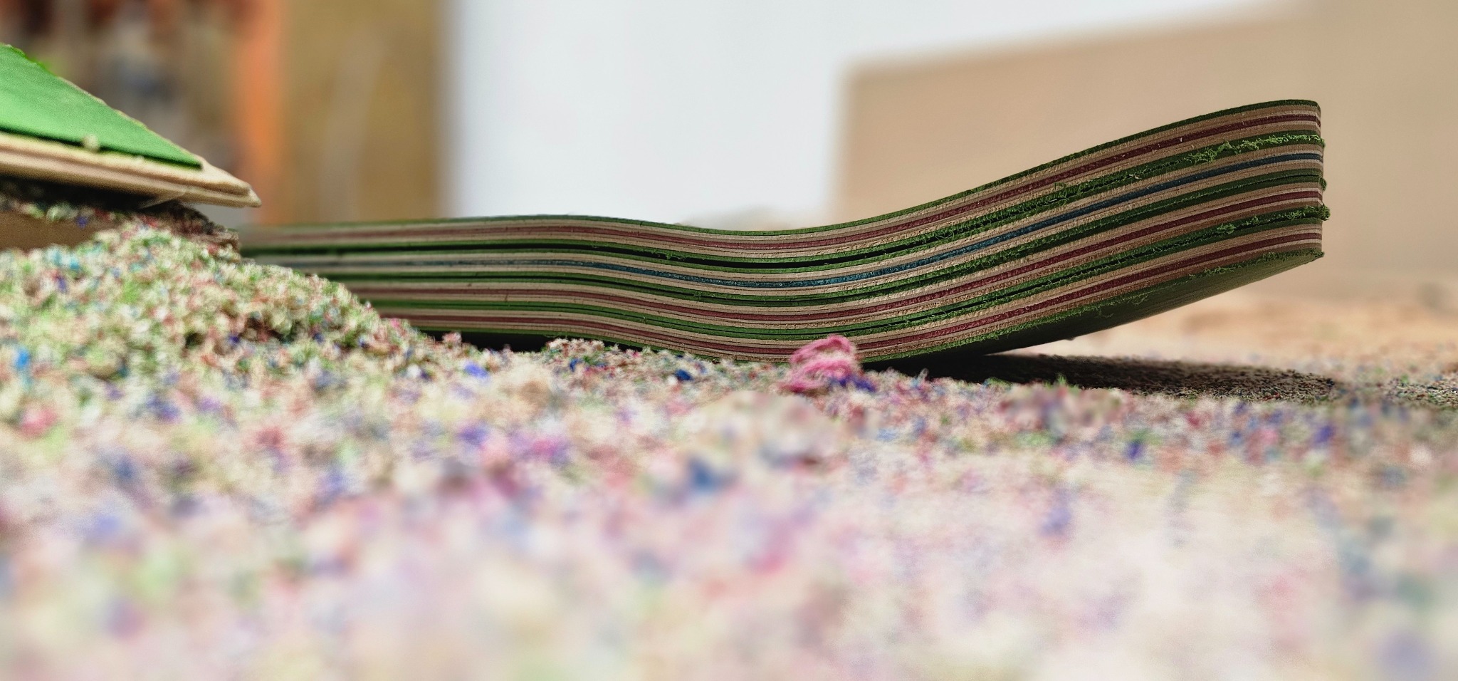 Multicolored skateboard veneer layers after pressing